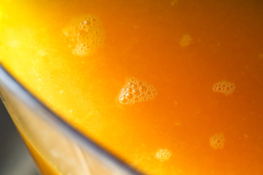 Golden amber full spectrum honey oil with tiny bubbles showing rich cannabinoid content