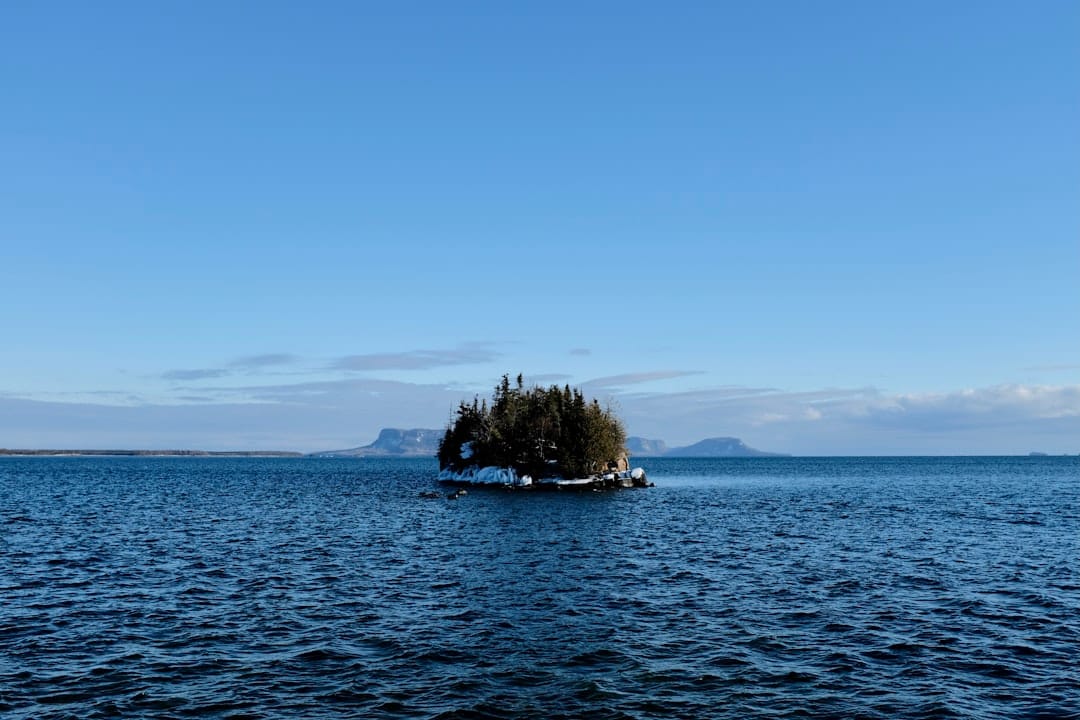 Scenic view of Lake Superior island near Thunder Bay Ontario with green trees and calm water