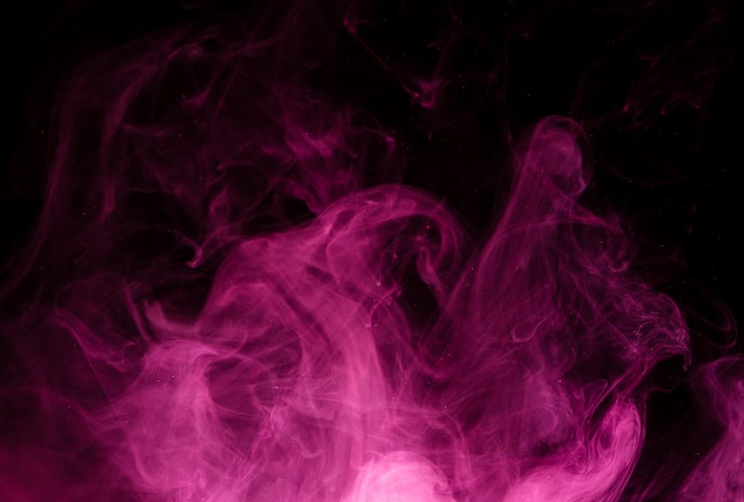 Pink and purple smoke swirling against a dark background evoking the Pink Gasoline cannabis strain