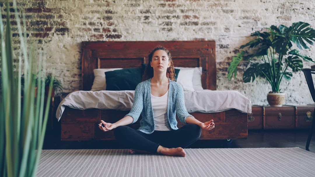 Woman meditating cross-legged representing mindful cannabis microdosing