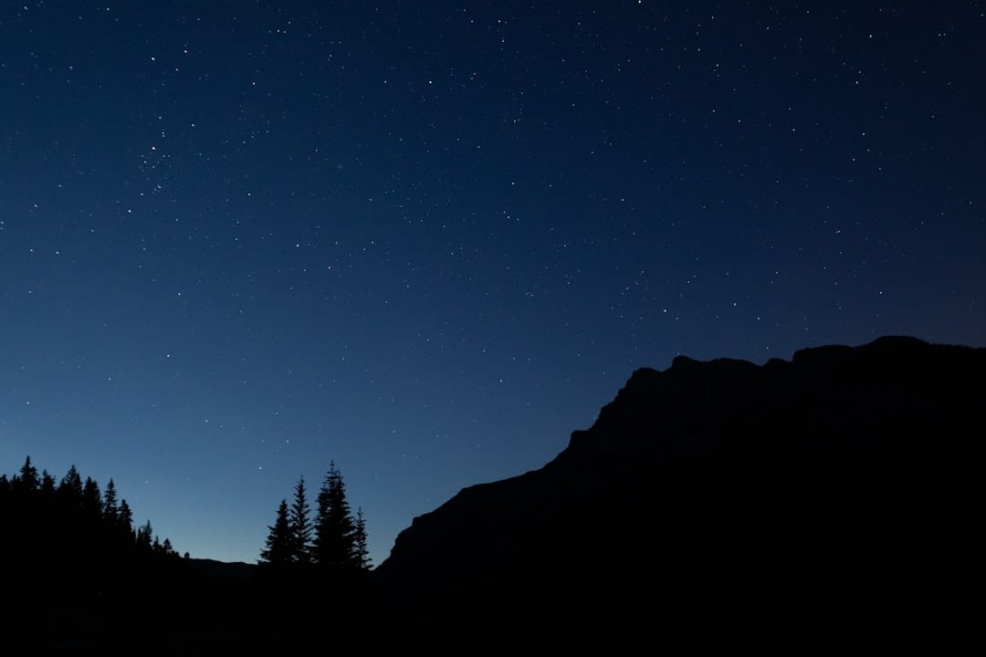 Starry night sky over mountain silhouettes ideal for evening cannabis relaxation