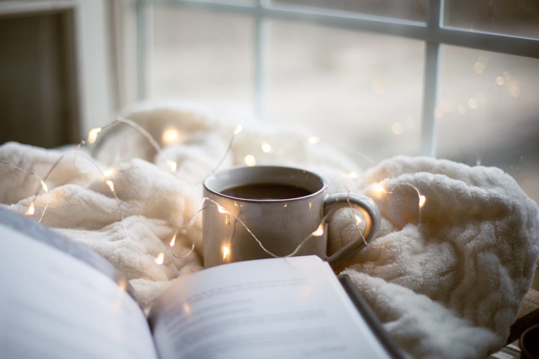 Cozy relaxing setting with coffee and a book on a blanket representing a calm comfortable environment for a mushroom experience