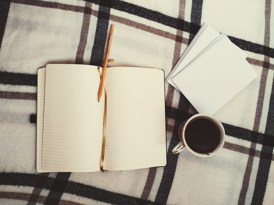 Journal book and coffee mug in cozy morning light representing focused productive daytime cannabis use