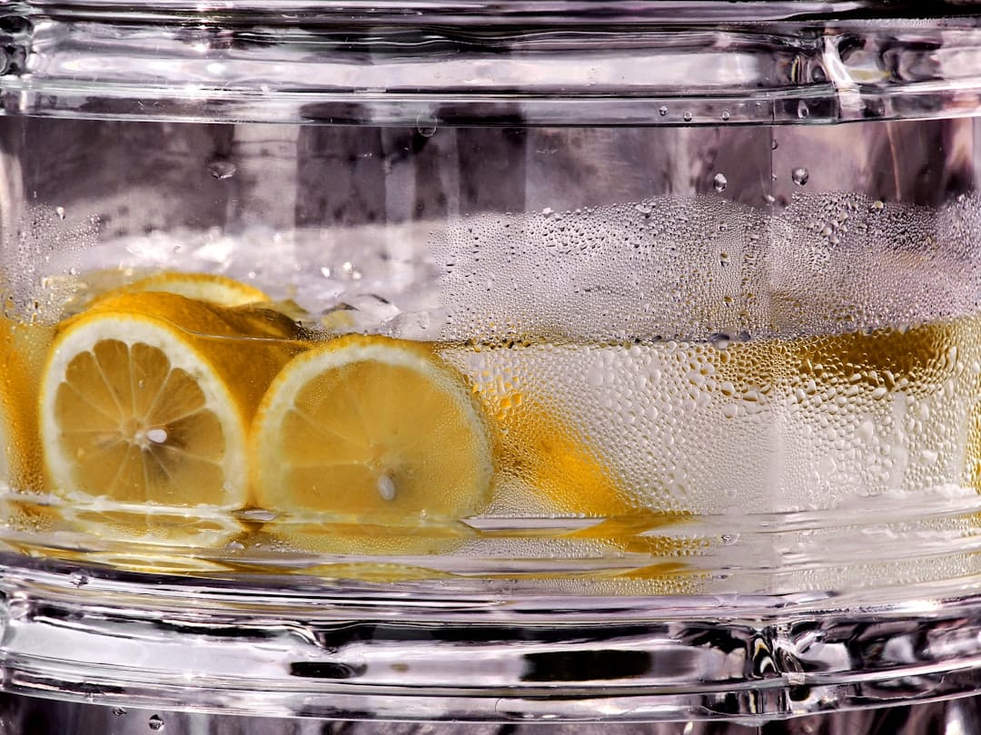 Refreshing cannabis-infused beverage with lemon slices floating in a clear glass
