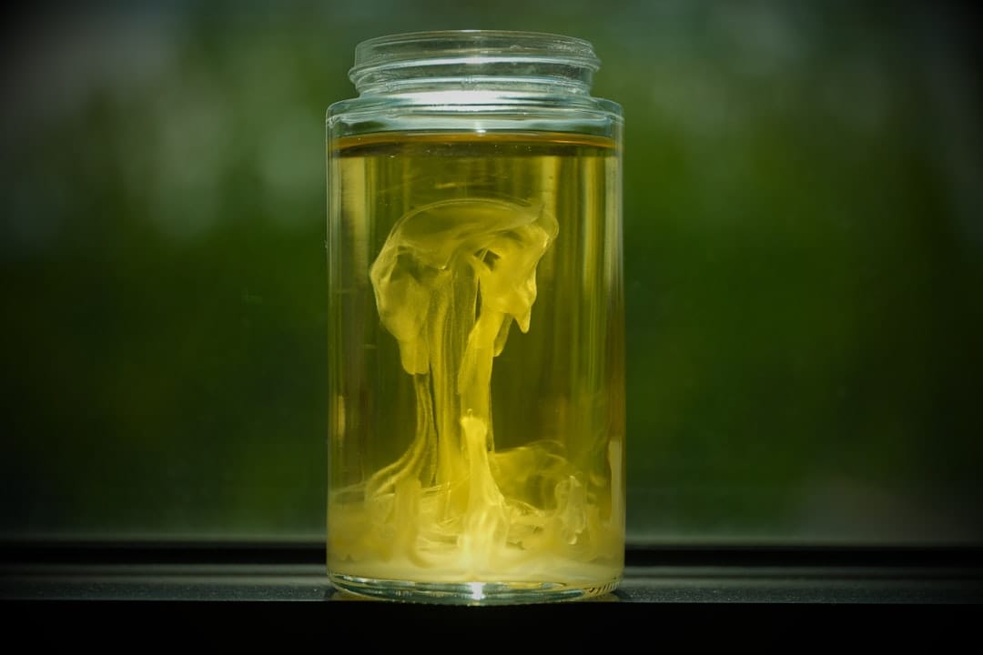 Golden cannabis concentrate swirling in a glass jar containing full spectrum minor cannabinoids