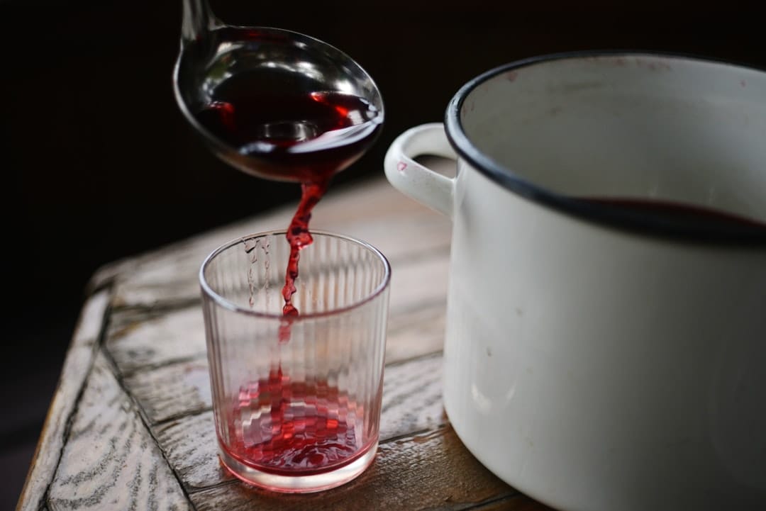 Colourful liquid being poured into a glass representing nano THC syrup infused drinks