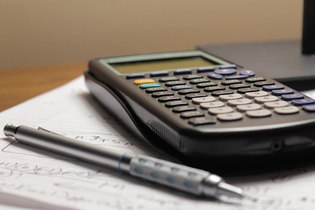 Calculator and pen on financial documents representing home grow budget planning