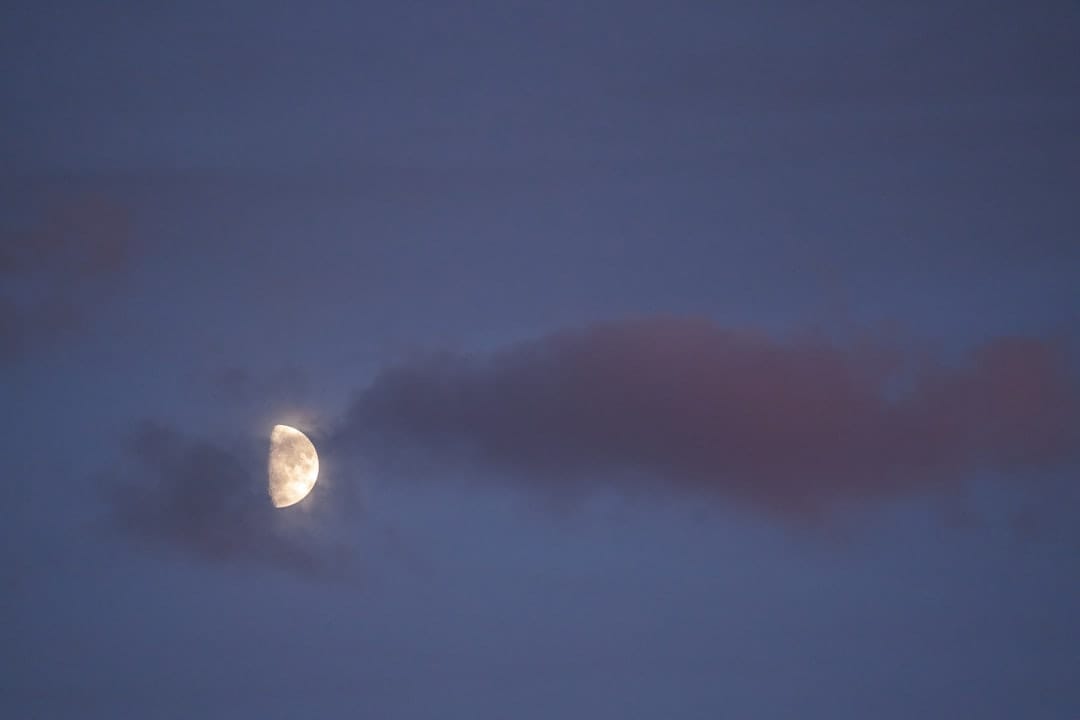 Moon glowing through clouds at night representing the calming sleep-promoting effects of CBN cannabinoid