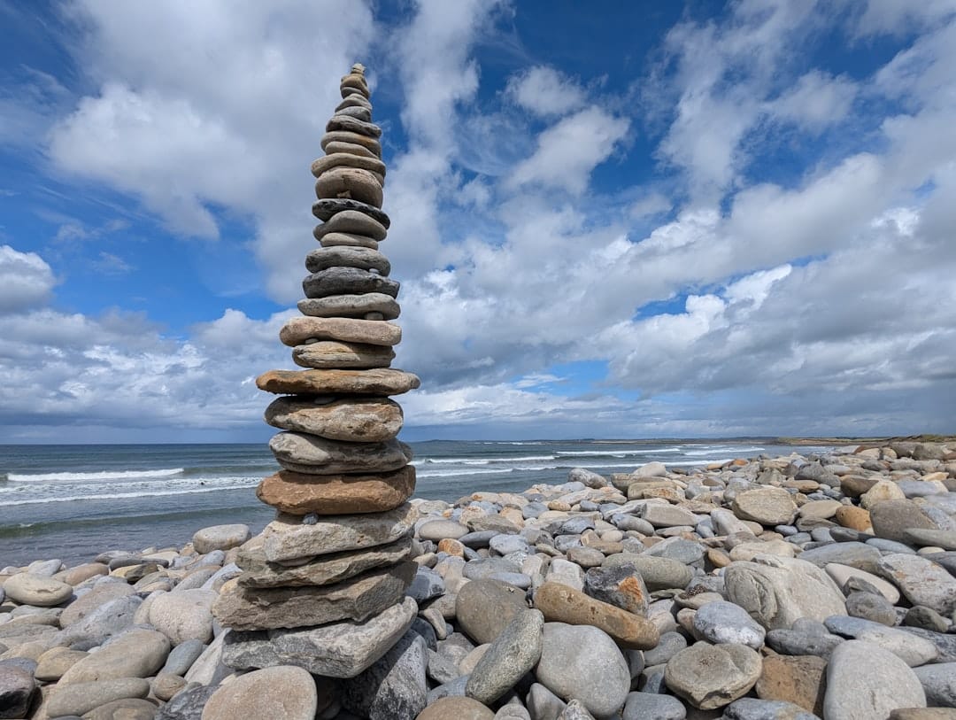 Stacked zen stones on a peaceful beach symbolising balance and calm for cannabis anxiety relief