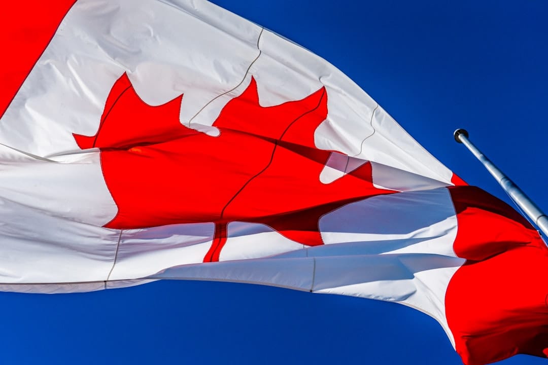 Canadian flag waving against blue sky representing Health Canada cannabis regulation changes