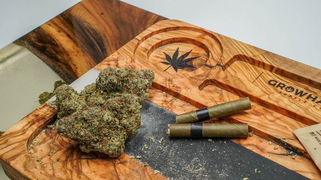 Premium cannabis pre-rolled joints displayed on a wooden surface