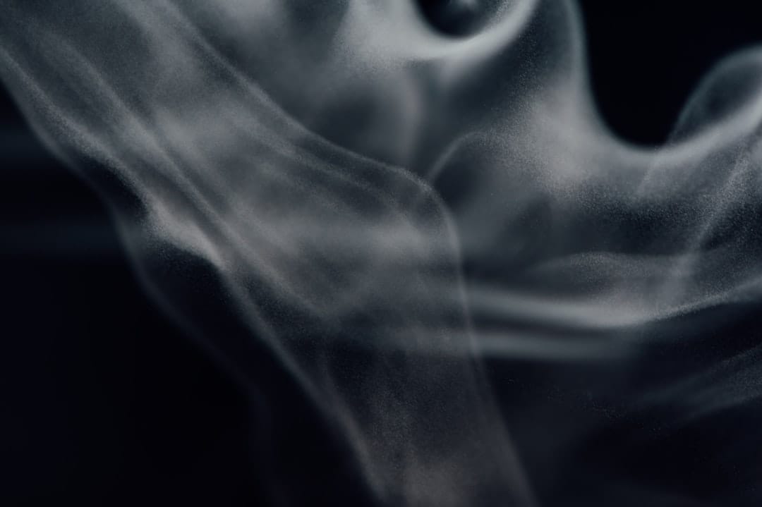 White smoke swirling against a dark background evoking the diesel terpene profile of Death Reaper
