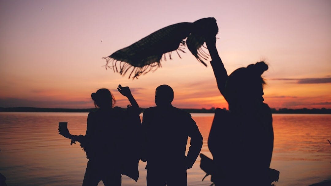 Friends celebrating together at sunset by the water for 4/20 in Canada
