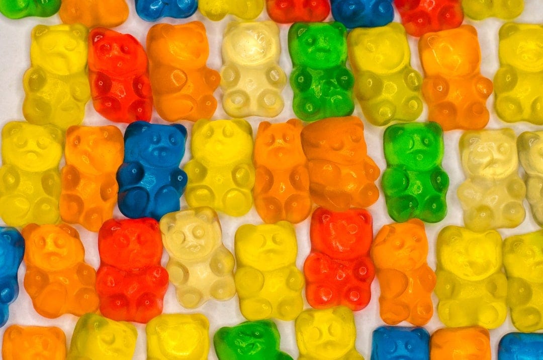 Colourful THC gummies arranged on a table representing edibles dosing