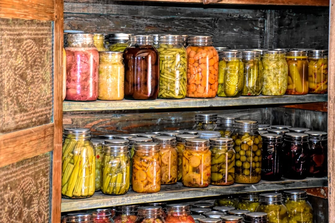Organized wooden shelf lined with glass jars ideal for storing cannabis flower