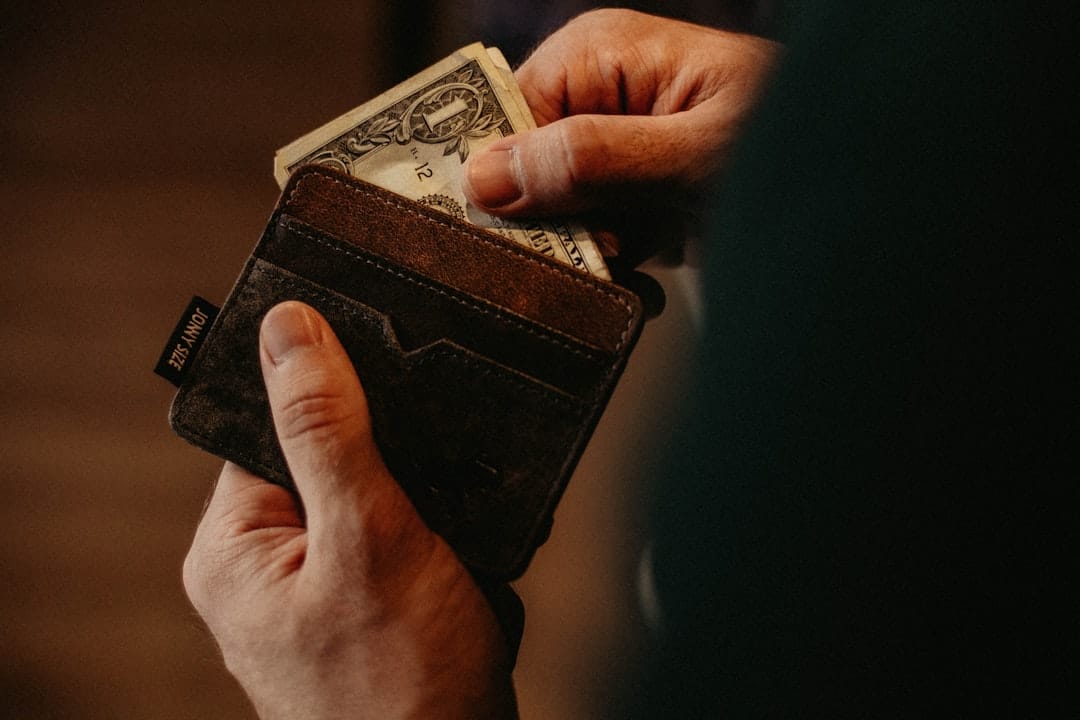 Person pulling money from wallet representing value savings on popcorn buds