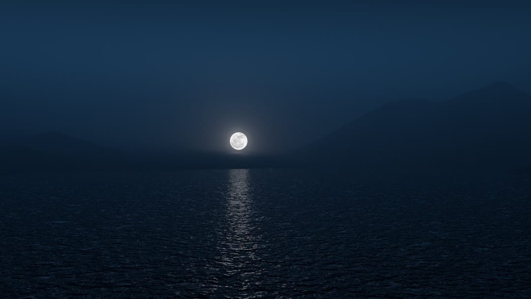 Calm moonlit lake at night symbolising the deep relaxation effects of indica cannabis