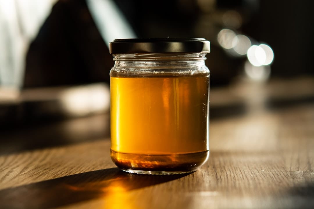 Glass jar of amber liquid resembling cold-cured live hash rosin
