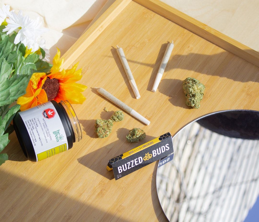 Cannabis buds on a wooden surface ready to be combined with temple ball hash in a joint