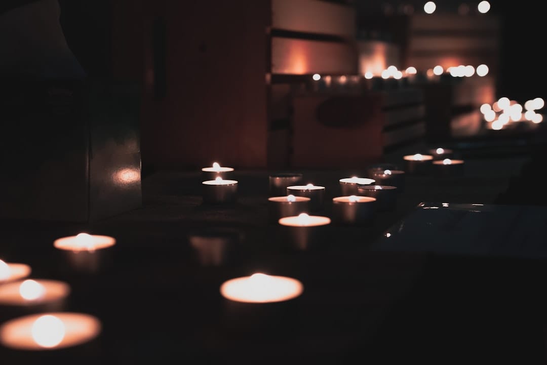 Lit candles on a wooden table evoking the evening relaxation mood of indica temple ball hash