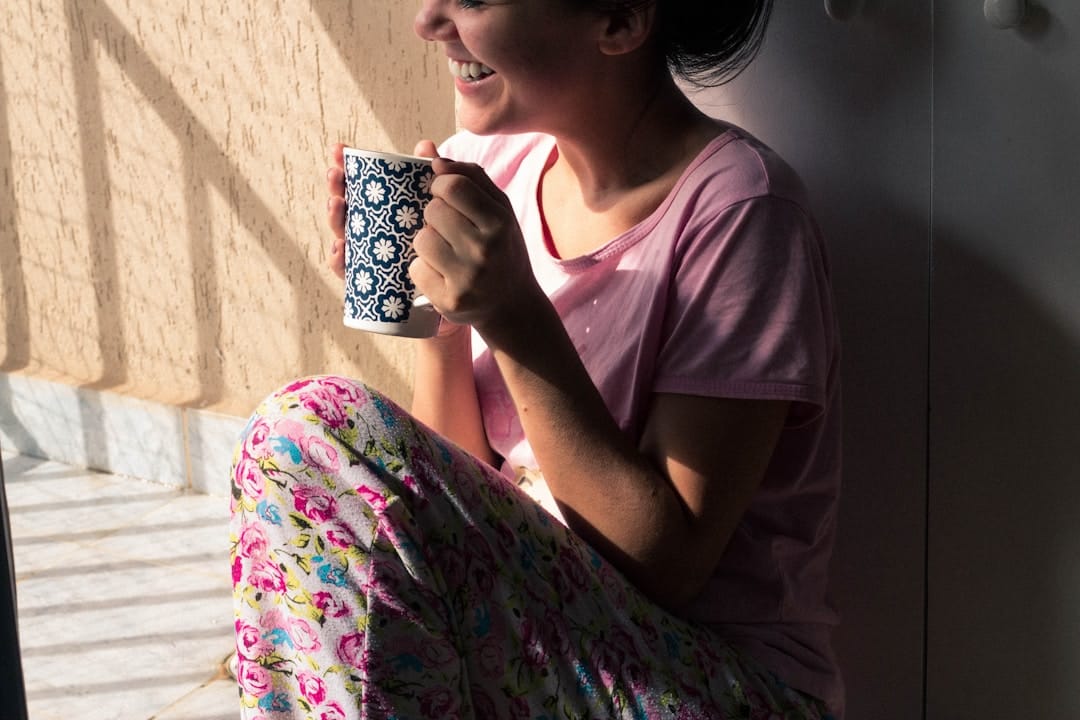 Woman holding a warm mug at home — cannabis wellness lifestyle