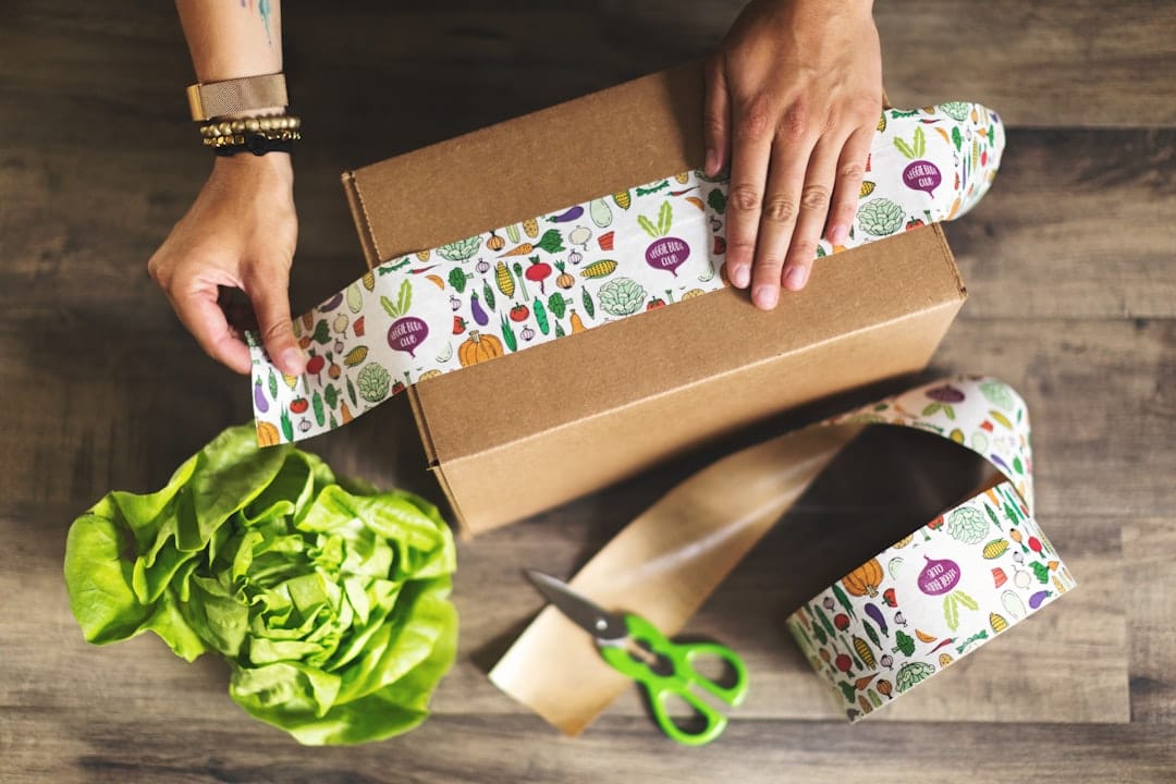 Person holding a brown parcel ready for delivery to a Baddeck address
