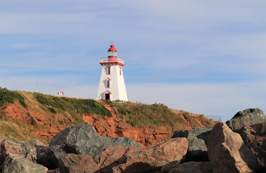 White lighthouse on a coastal hill in Prince Edward Island, evoking the maritime feel of Summerside