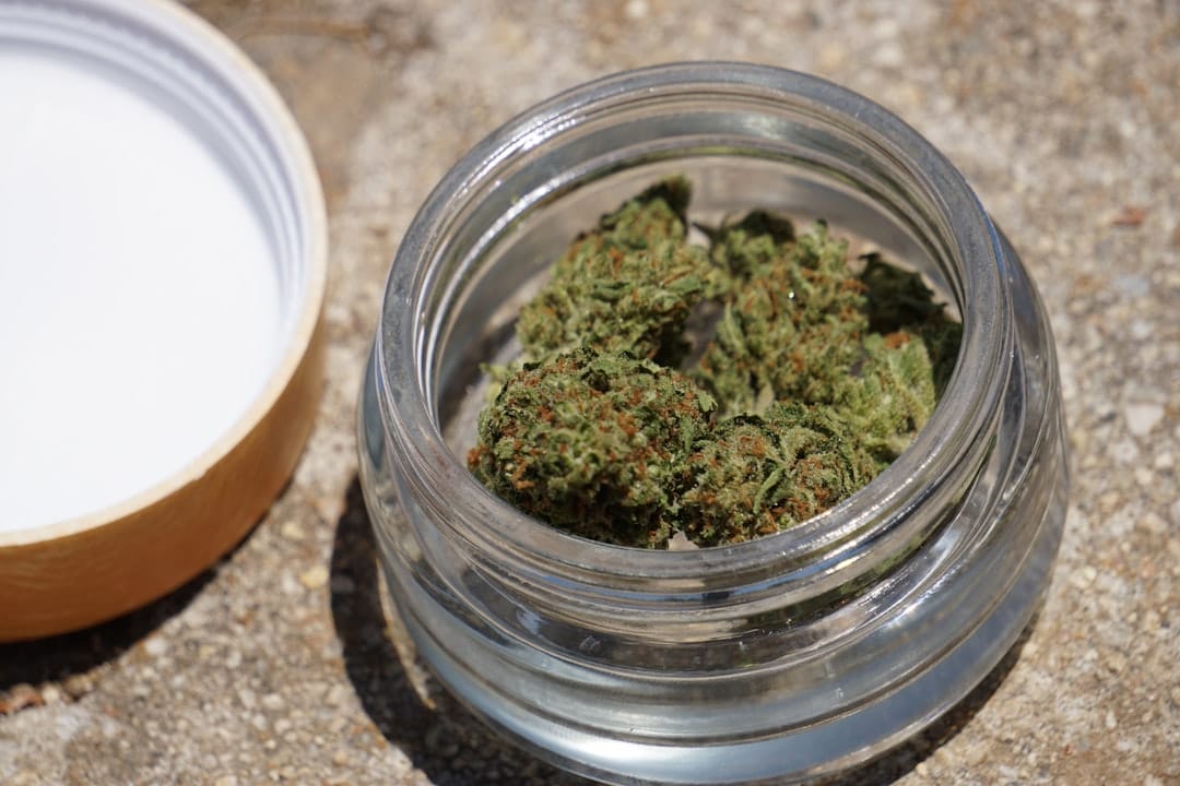 Cannabis flower in clear glass jar representing the wholesale producer side of Canada's cannabis market