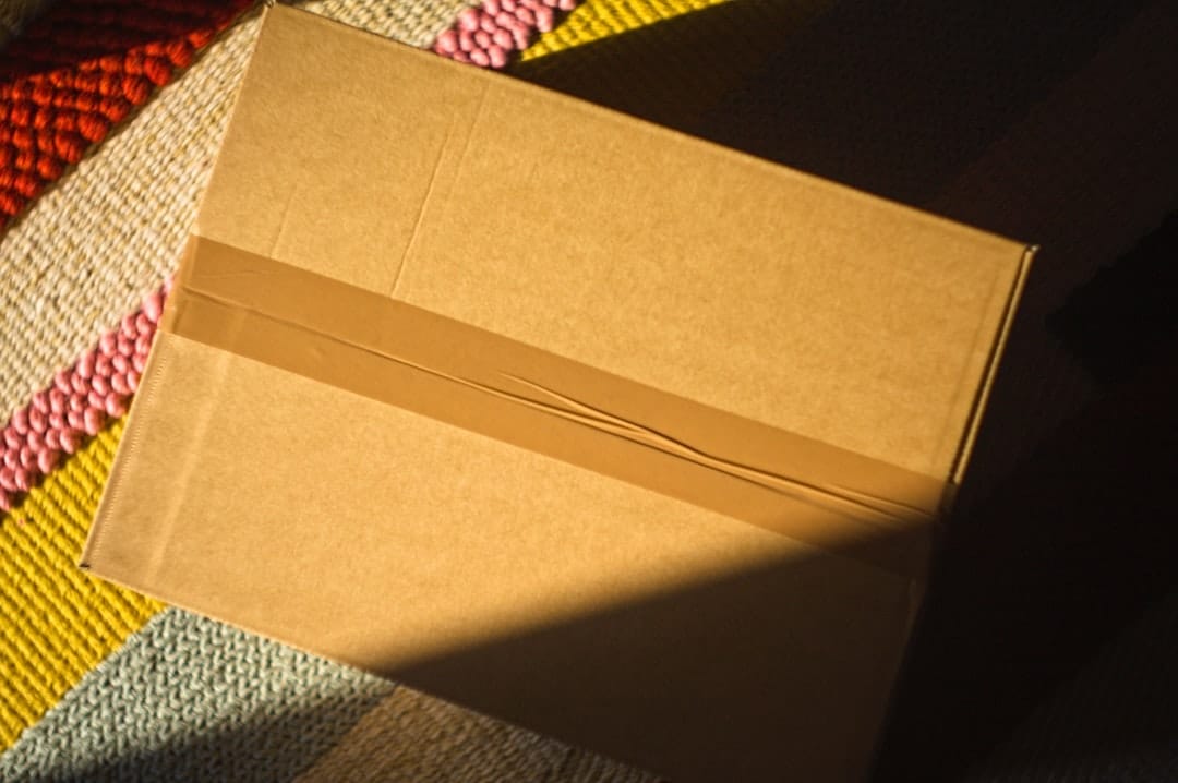 Brown cardboard parcel sealed with tape ready for Canada Post Xpresspost delivery to rural Nova Scotia