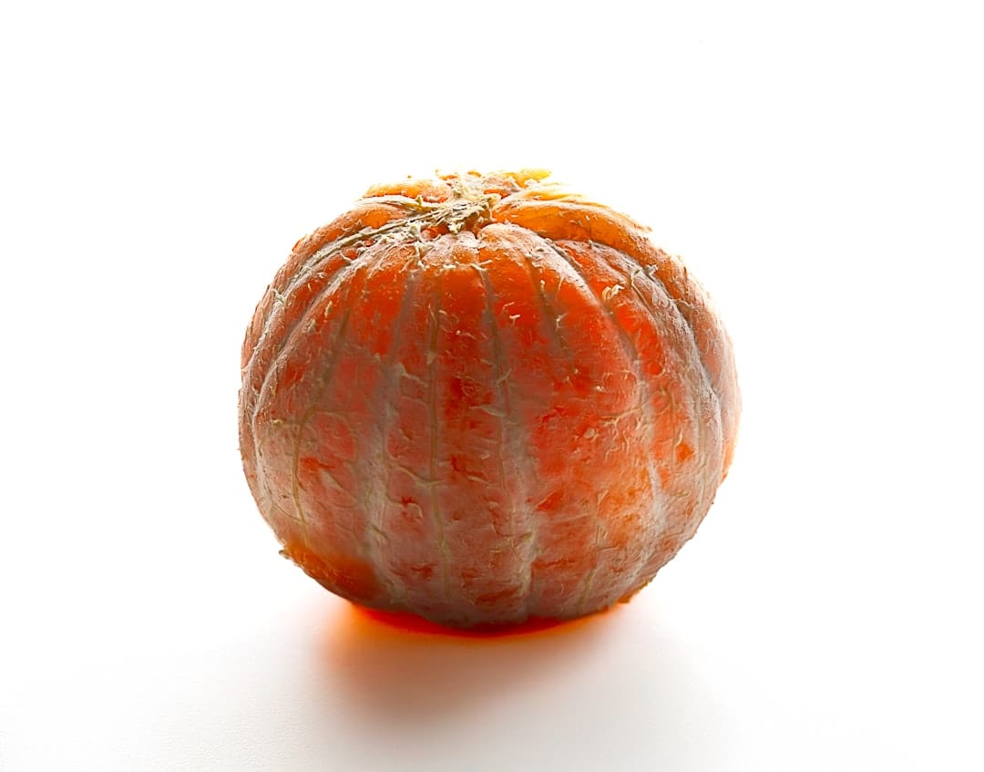 Peeled mandarin orange showing citrus oils rich in limonene terpenes