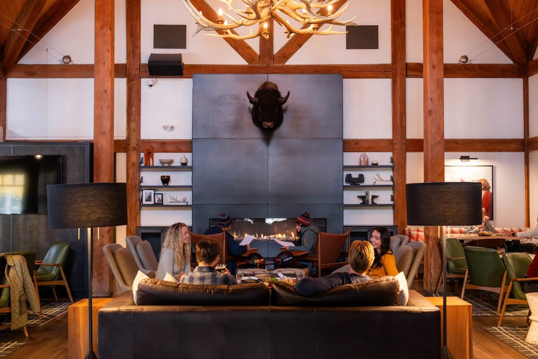 Cozy mountain lodge interior with fireplace and view of snow-covered Canadian Rockies