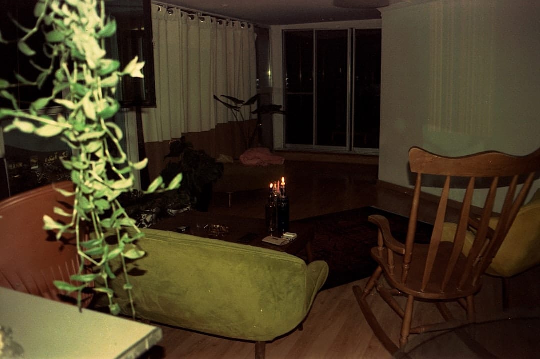 Cozy dimly lit living room with candle for evening cannabis relaxation