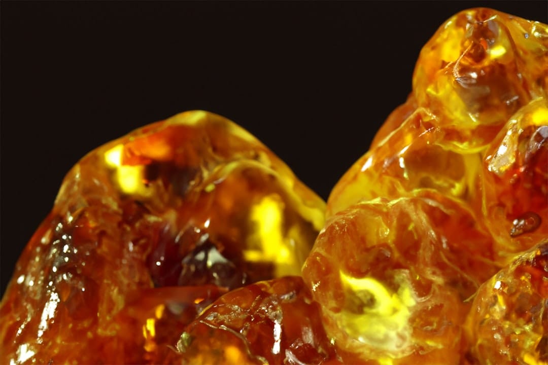 Amber-yellow sugar wax cannabis concentrate texture close up