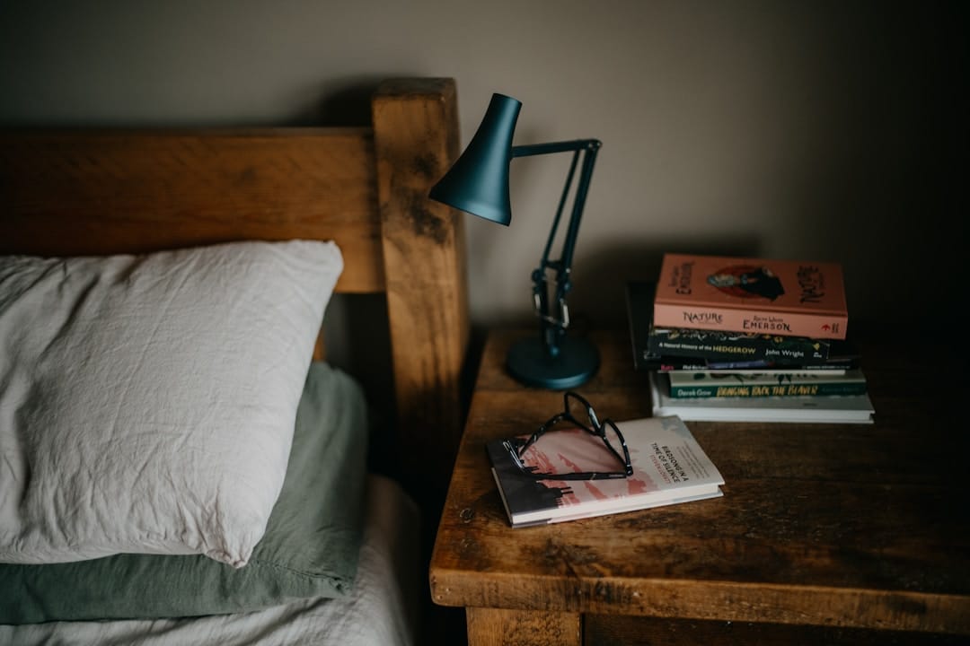 Books and lamp on bedside nightstand — cannabis as sleep aid alternative