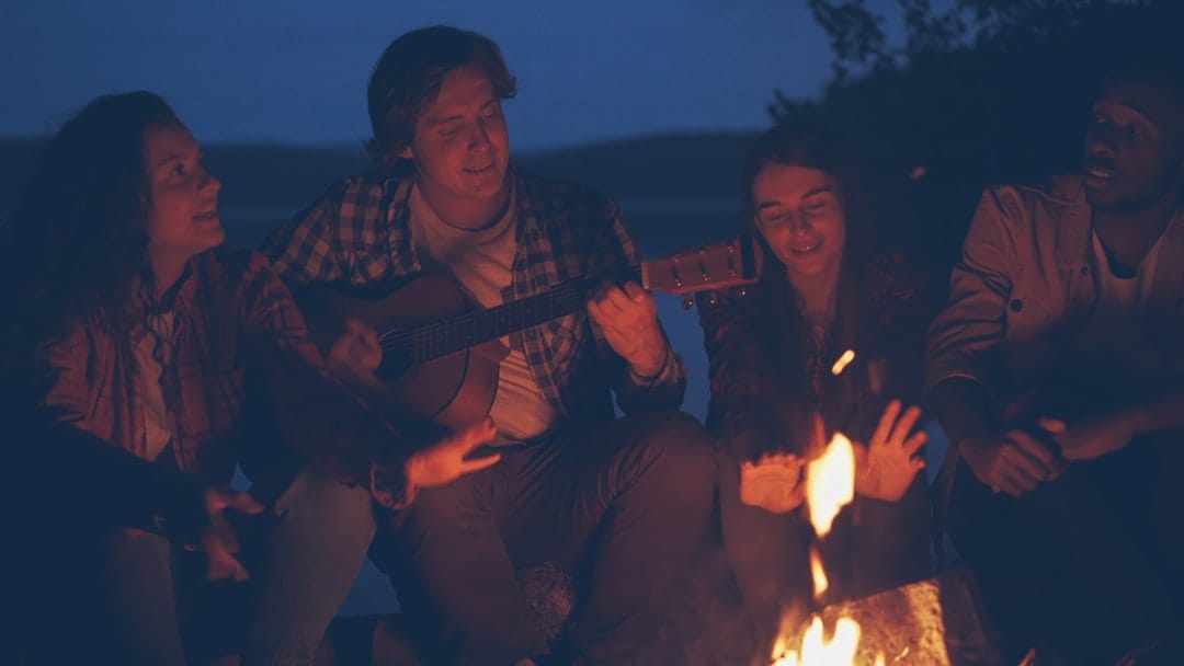 Friends gathered around a campfire