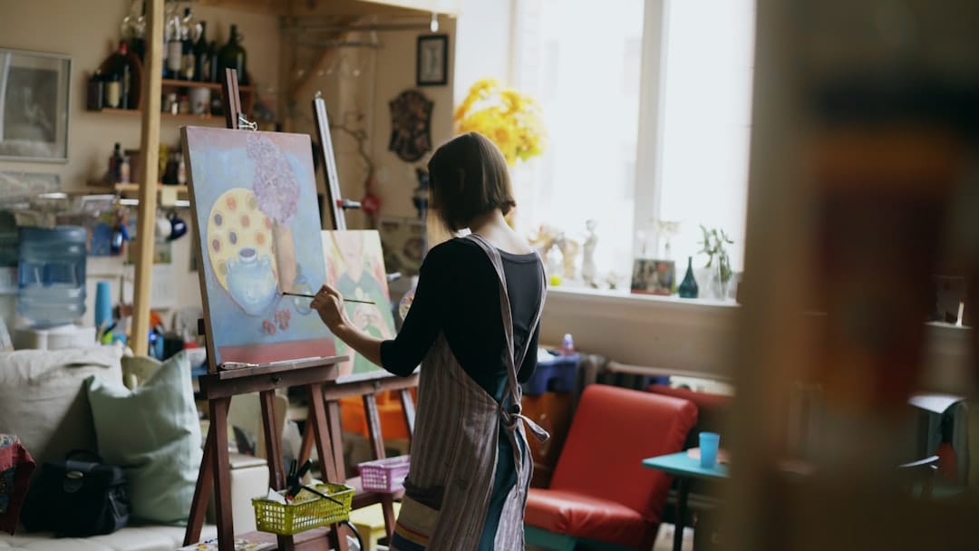 Artist painting on canvas in creative studio representing creative effects of cannabis