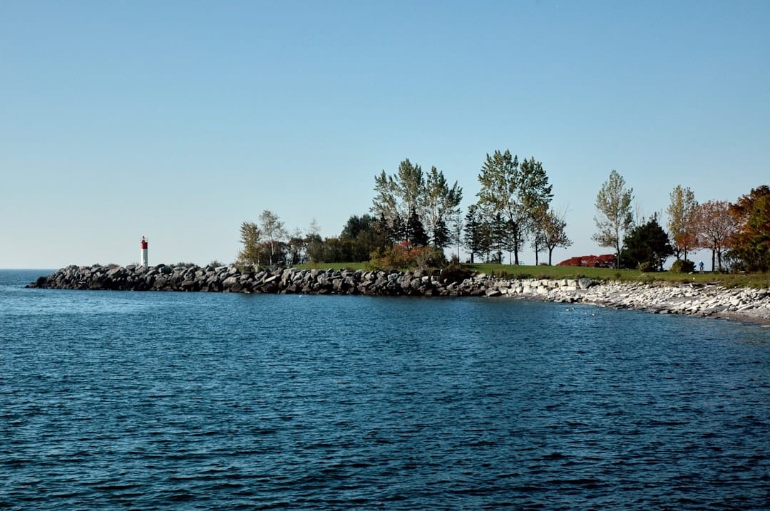 Rocky South Shore Nova Scotia coastline near Liverpool with trees and blue Atlantic sky