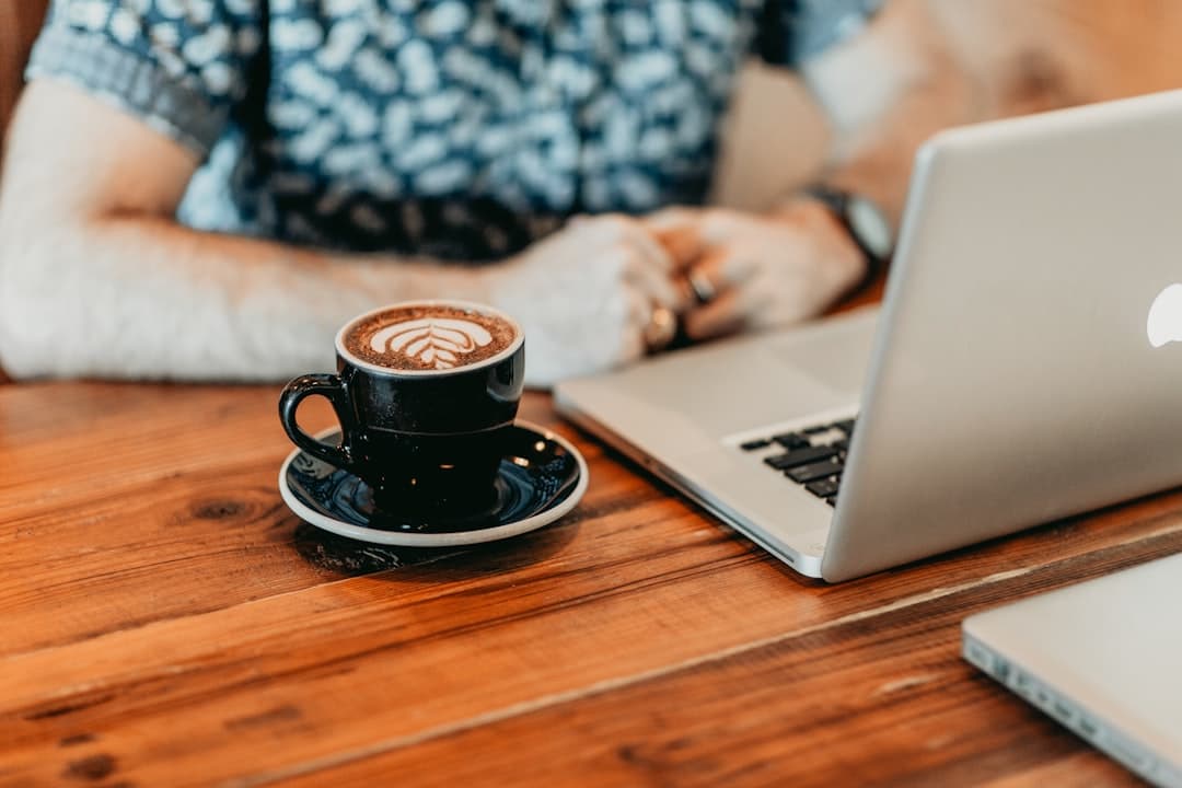 Coffee mug beside laptop on desk reflecting Waterloo student study session