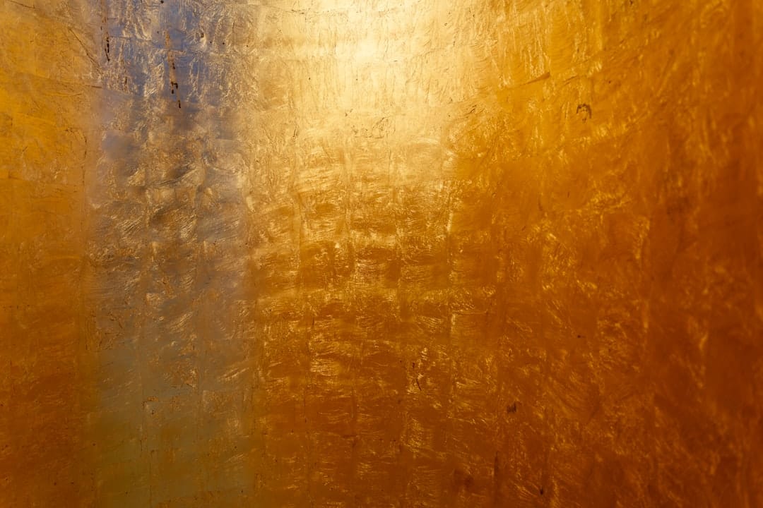 Golden amber textured surface resembling live resin cannabis concentrate