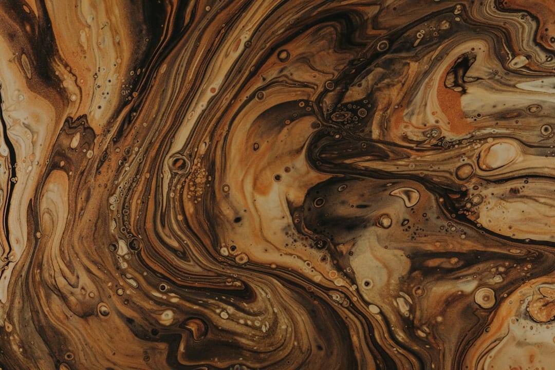 Dark brown hash concentrate with rich organic texture resembling quality cannabis resin