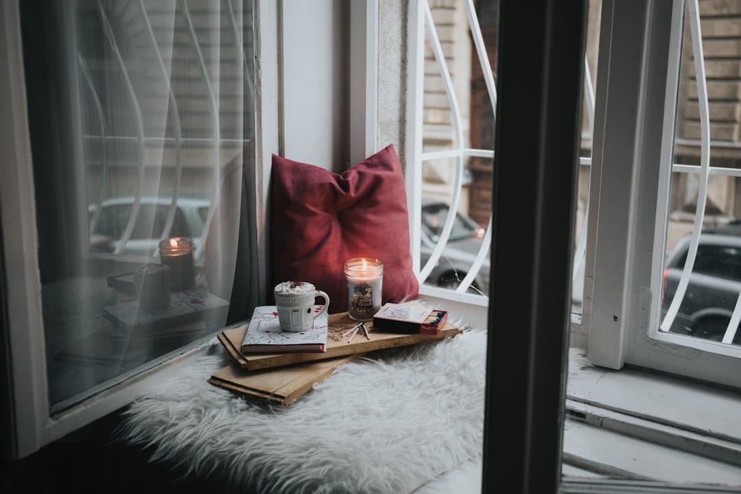 Warm candle glow beside a comfortable pillow evoking deep relaxation