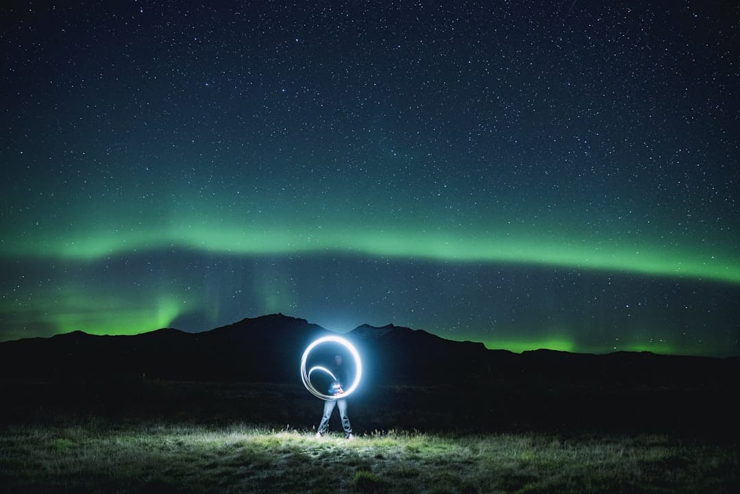 Green aurora borealis northern lights dancing across the Arctic night sky