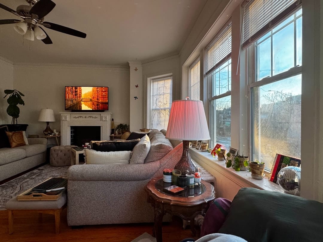 Cozy living room with warm fireplace and large windows perfect for a relaxing evening at home