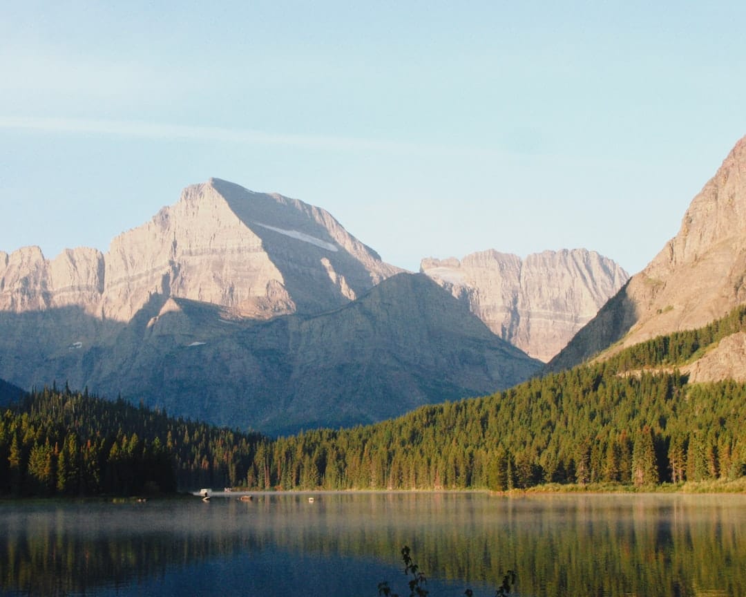 Majestic mountains reflected in a calm lake at dawn in British Columbia