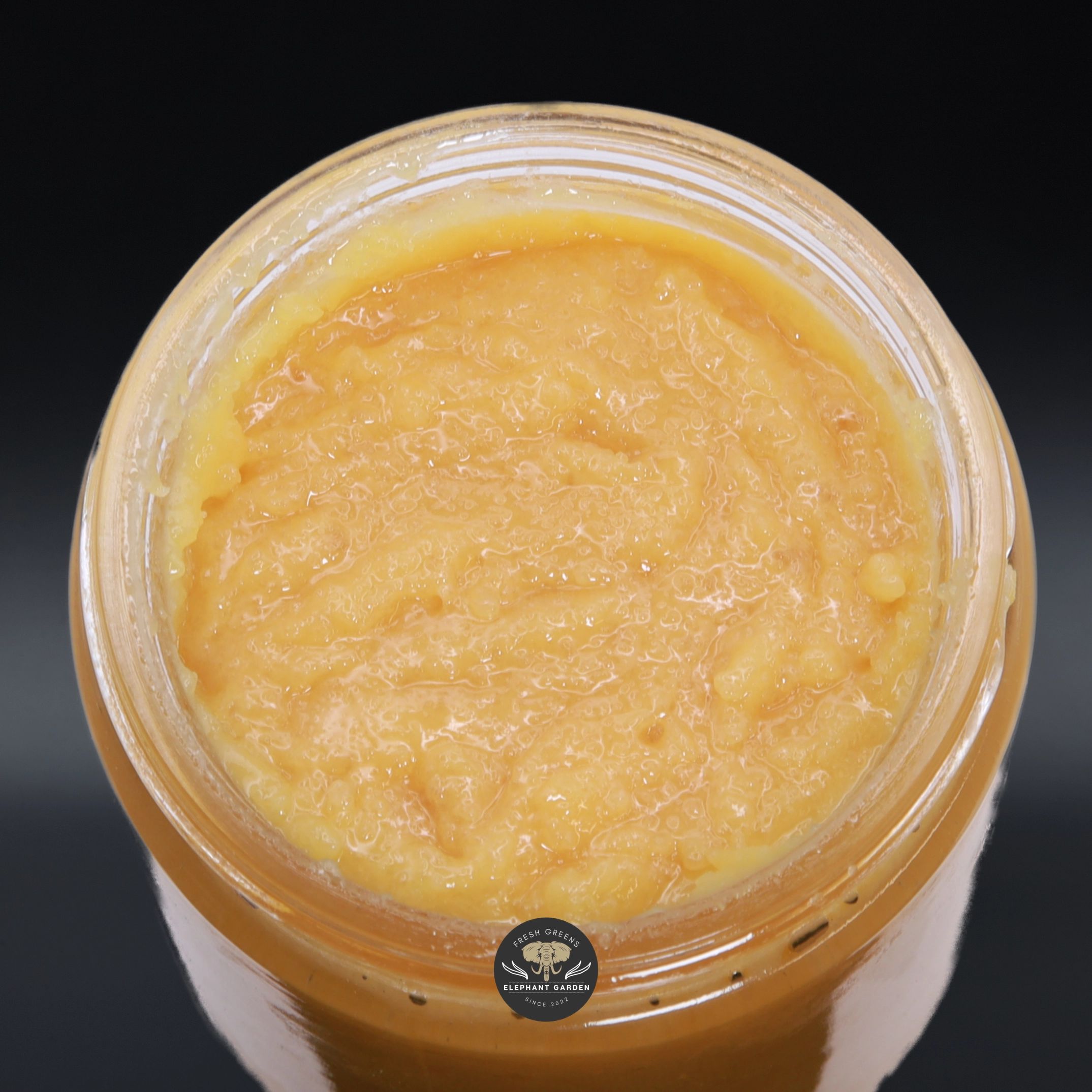 Strawberry Gum Live Resin, golden-orange live resin concentrate in an open glass jar