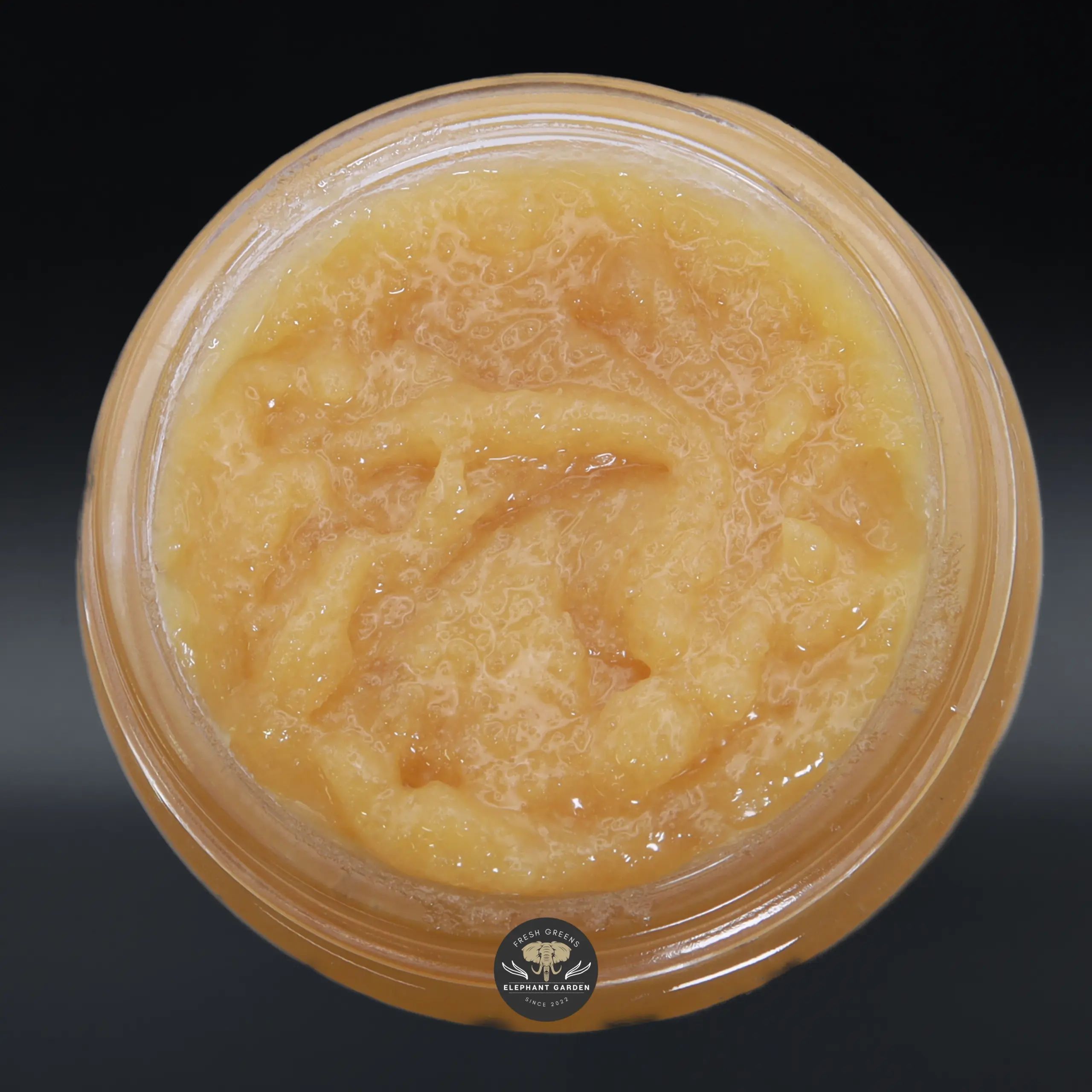 Slurricane live resin concentrate, amber sauce in a glass jar