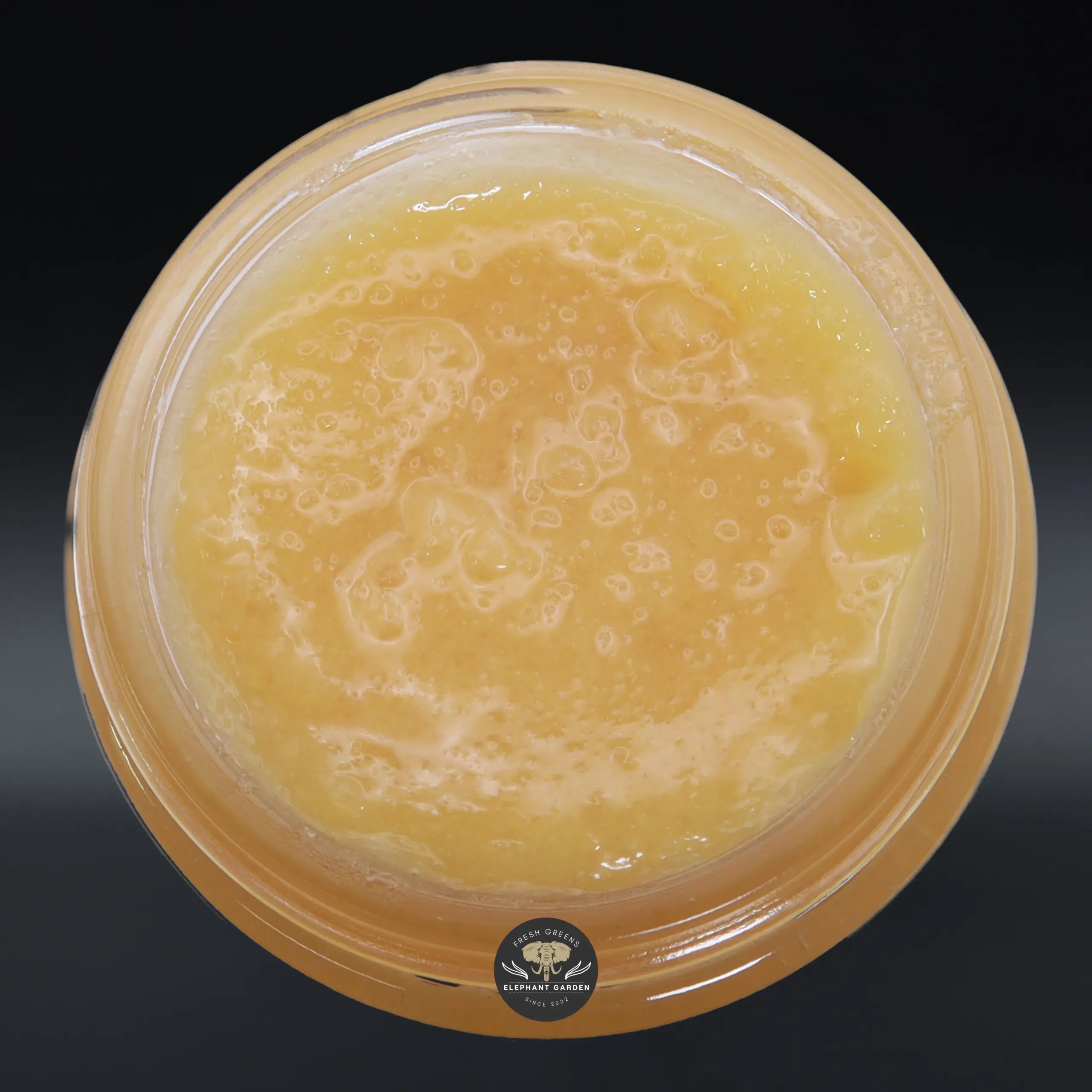 Sunset Sherbert live resin concentrate, amber sauce in a glass jar