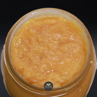 Blue Dream Live Resin, golden-orange live resin sauce in a glass jar, close-up product photo