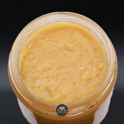 Strawberry Gum Live Resin, golden-orange live resin concentrate in an open glass jar