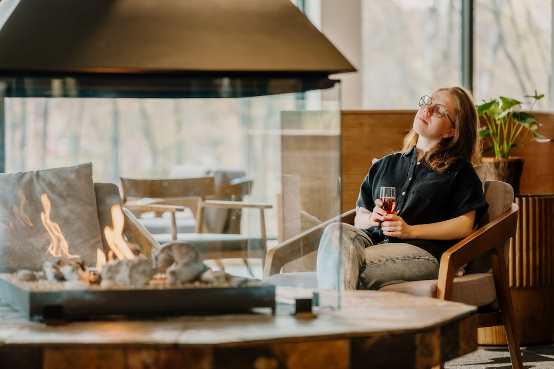 Woman relaxing by a cozy fireplace at home during a peaceful evening